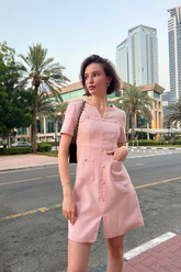 a lady in a pink single-breasted mini dress